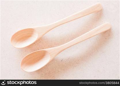 Top view of wooden spoons on brown background, stock photo