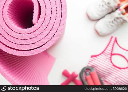 Top view of yoga and fitness equipments on white background