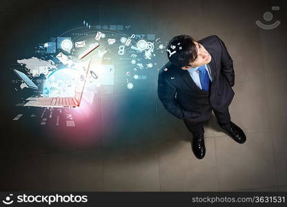 Top view of young businessman making decision