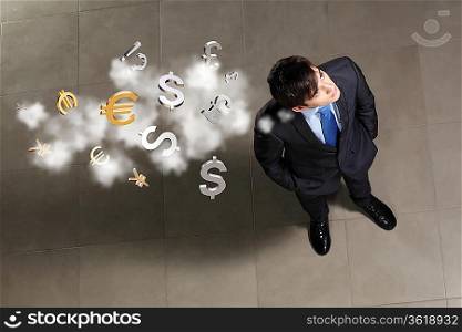 Top view of young businessman making decision currency signs in air