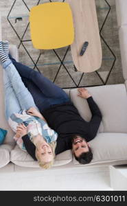 top view of Young couple on the sofa watching television together at home