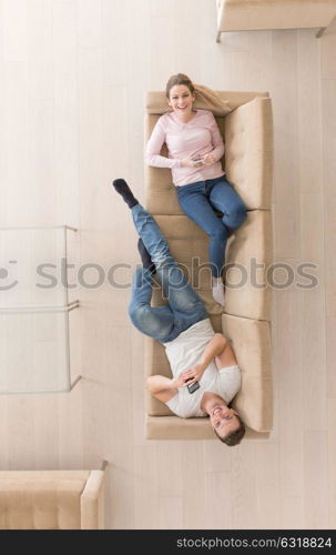 top view of Young couple on the sofa watching television together at home