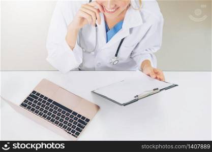 Top view of young female doctor working in hospital office. Medical and healthcare concept.. Top view of doctor working in hospital office.