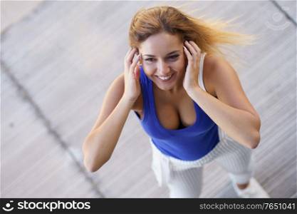 Top view of young girl moving her hair wild outdoors. View from above of young girl moving her hair wild