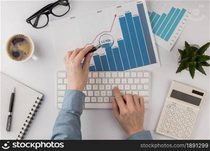 top view office desk with growth chart analyzed with magnifying glass. Resolution and high quality beautiful photo. top view office desk with growth chart analyzed with magnifying glass. High quality and resolution beautiful photo concept