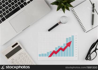 top view office desk with growth chart laptop. Resolution and high quality beautiful photo. top view office desk with growth chart laptop. High quality and resolution beautiful photo concept