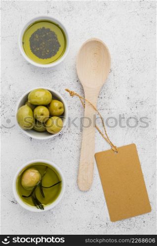 top view olives oil with spoon