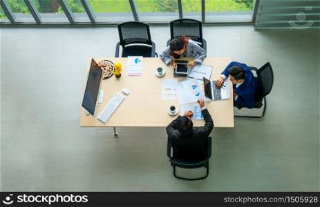 Top view on a group of businessman and businesswoman having a meeting and making a business commitment.