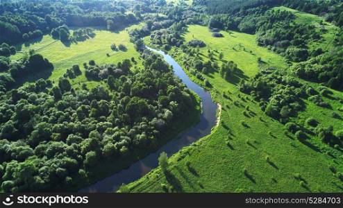 top view on field, trees and river