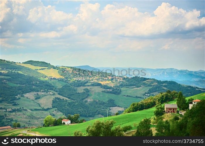 Top view on idyllic hills, green meadows and villages of Italian Tuscany
