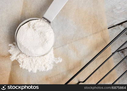 Top view on measuring cup filled with flour.