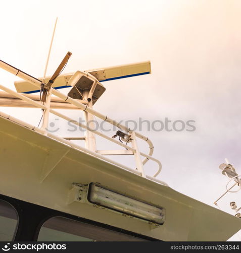 Top view on sailing boat or yacht roof eqipment, radars. Cloudy sky in background.. Sailing boat roof equipment.