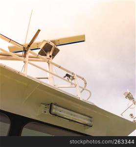 Top view on sailing boat or yacht roof eqipment, radars. Cloudy sky in background.. Sailing boat roof equipment.