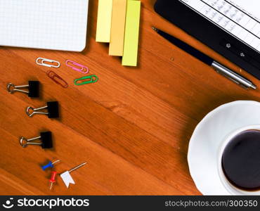 Top view on wooden table with office supplies. Workspace desk with office supplies