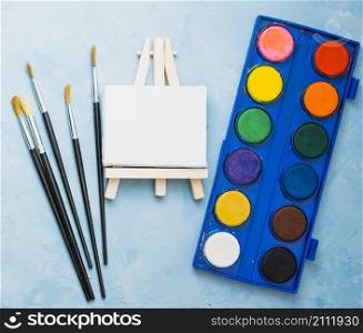 top view paint brushes mini easel watercolor palette
