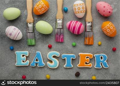 top view paint brushes with colorful easter eggs