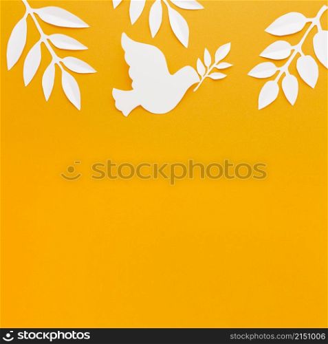 top view paper dove with copy space paper leaves