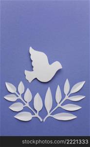 top view paper dove with leaves copy space