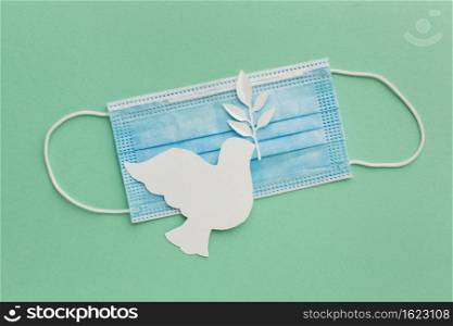 top view paper dove with medical mask