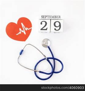 top view paper heart with date stethoscope