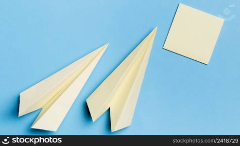 top view paper planes with sticky notes desk