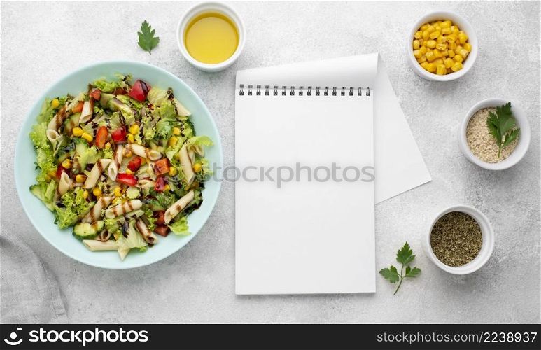 top view pasta salad with balsamic vinegar blank notepad