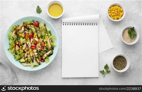 top view pasta salad with balsamic vinegar blank notepad
