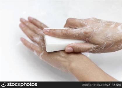 top view person washing hands with solid soap
