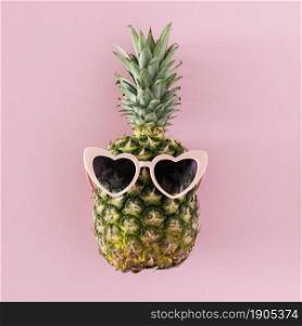 top view pineapple with heart shaped sunglasses. Beautiful photo. top view pineapple with heart shaped sunglasses