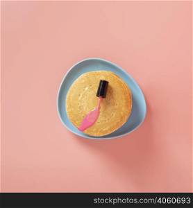 top view pink nail polish pancakes with plain background
