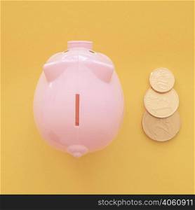 top view pink piggy bank with coins