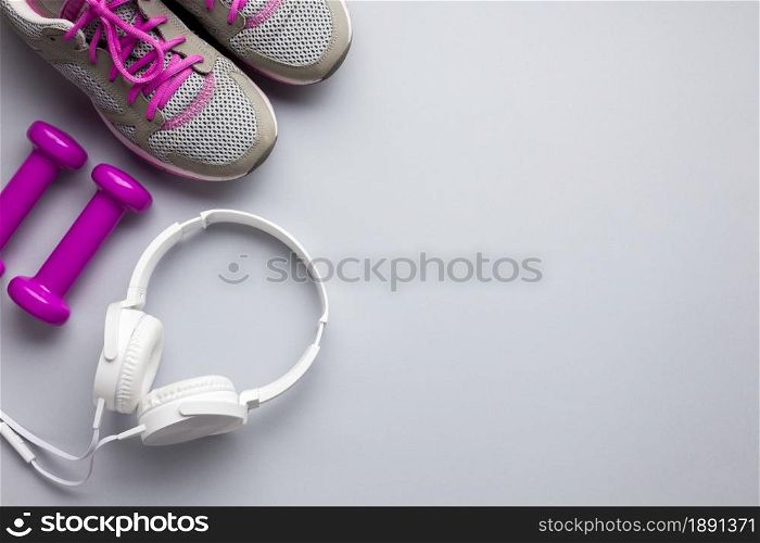 top view pink sports attributes with headphones. Resolution and high quality beautiful photo. top view pink sports attributes with headphones. High quality and resolution beautiful photo concept