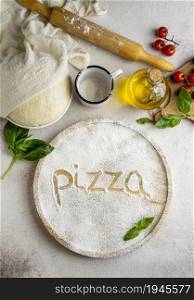 top view pizza dough with tomatoes word written flour. High resolution photo. top view pizza dough with tomatoes word written flour. High quality photo