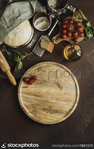 top view pizza dough with wooden board tomatoes. Resolution and high quality beautiful photo. top view pizza dough with wooden board tomatoes. High quality and resolution beautiful photo concept