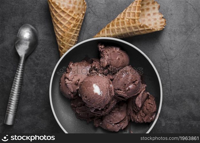 top view plate with chocolate ice cream scoops cones beside. High resolution photo. top view plate with chocolate ice cream scoops cones beside. High quality photo