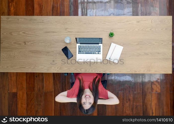 Top view Portrait of Asian business woman with technology laptop and notebook for work from home with relax feeling in outdoor home,startups and business owner, social distance and self responsibility
