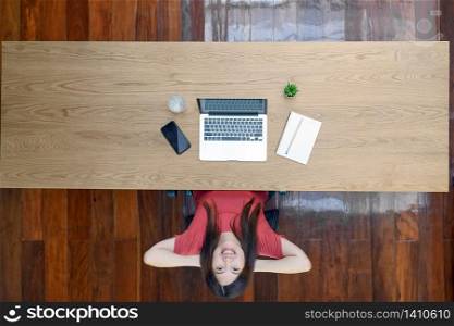 Top view Portrait of Asian business woman with technology laptop and notebook for work from home with relax feeling in outdoor home,startups and business owner, social distance and self responsibility