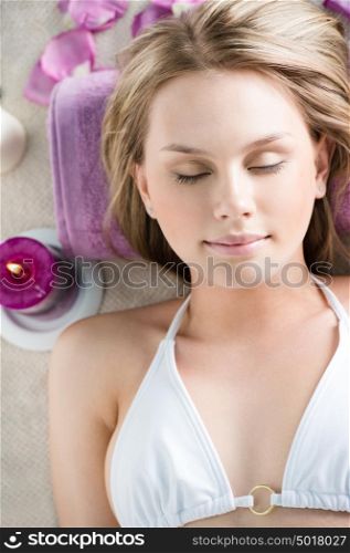 Top view portrait of young beautiful woman in spa environment