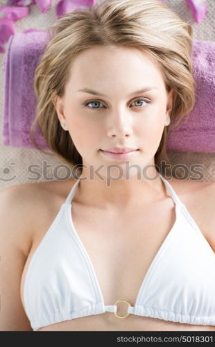 Top view portrait of young beautiful woman in spa environment