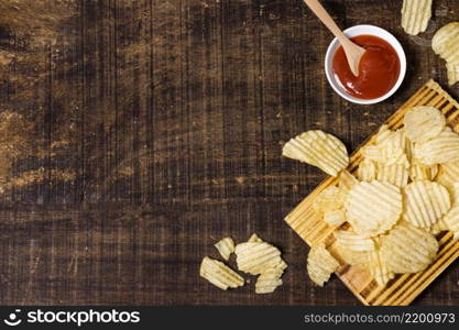 top view potato chips with ketchup copy space