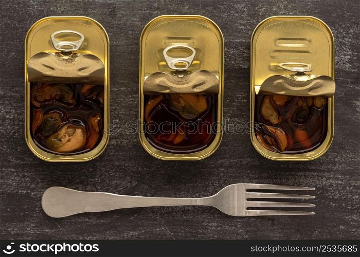 top view preserved mussels cans with fork