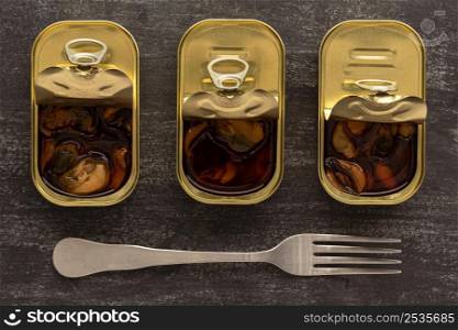 top view preserved mussels cans with fork