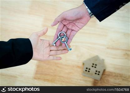 Top view real estate agent give house key to family couple after signed contract agreement home loan