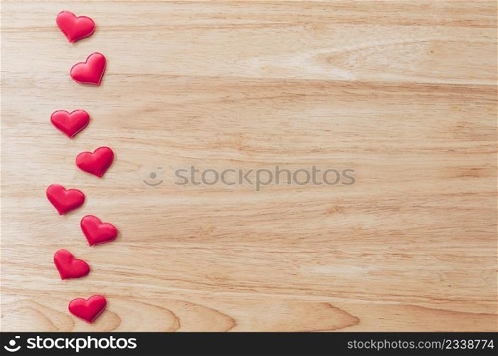 Top view red heart on wood table background with copy space.