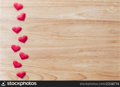 Top view red heart on wood table background with copy space.