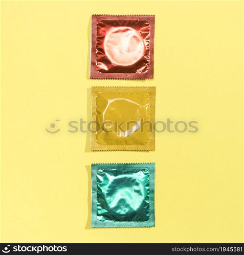top view red yellow green condoms. High resolution photo. top view red yellow green condoms. High quality photo