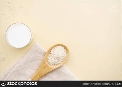 top view rise spoon with milk copy space. Resolution and high quality beautiful photo. top view rise spoon with milk copy space. High quality and resolution beautiful photo concept