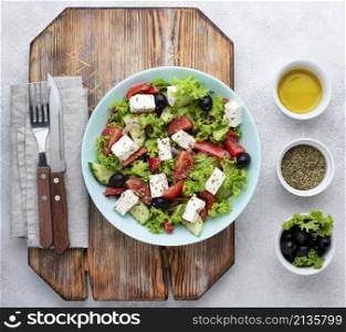 top view salad with feta cheese cutting board with olives