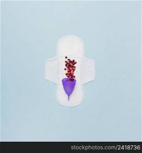 top view sanitary towel with red sequin menstrual cup