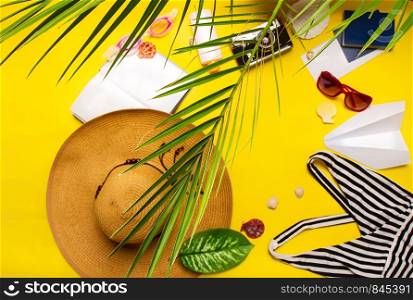 top view set of women's beach accessories and things for relaxation on a bright yellow background. women's beach accessories